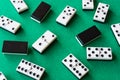 Top view of domino pieces, covered and uncovered, unfocused those in the background, on green mat to play Royalty Free Stock Photo