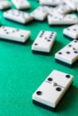 Top view of domino pieces, the two double focused, the rest out of focus, on green mat vertically Royalty Free Stock Photo