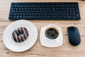 top view of doughnut, coffee cup, computer mouse and computer keyboard Royalty Free Stock Photo