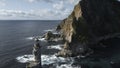 Top view of dramatic landscape of rocky island and lighthouse in sea. Clip. Cinematic fairy-tale landscape of rocky cape Royalty Free Stock Photo