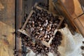 drawer of a coffee grinder filled with grain on rustic wooden background Royalty Free Stock Photo