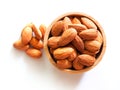 Above of dried almonds in wooden bowl isolated on white background Royalty Free Stock Photo