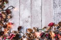Top view of Dried flowers with Christmas lights on wooden table background. Free space for your text. Royalty Free Stock Photo