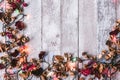 Top view of Dried flowers with Christmas lights on wooden table background. Free space for your text. Royalty Free Stock Photo