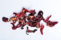 Top view of dried hibiscus petals on the white surface