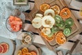 Top view of dried kiwis, bananas, apples, pumpkins, tangerines, grapefruits placed on wooden boards, rack and glasses