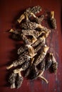 Top view of dried morels on a red wooden board