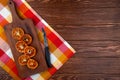 top view of dried orange slices with kitchen knife on a wooden cutting board on wooden background with copy space Royalty Free Stock Photo