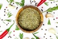 Top view of dried rosemary spice in a round wooden bowl with flat lay red chilli pepper, peppercorns and garlic Royalty Free Stock Photo