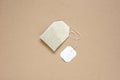 top view of dried tea bag with blank white paper tag placed on brown paper, copy space concept Royalty Free Stock Photo