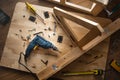 Top view of drill tool and another equipment on wood table furniture.assembly, improvement or repairing home interior