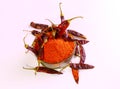 Top view dry red chilly peppers and powder of dried red chilies in a bowl in the light background