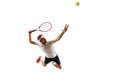 Top view. Dynamic image of sportsman, tennis player in motion, serving ball with racket, playing isolated over white Royalty Free Stock Photo