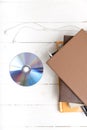 Top view of earphone with stack of book and dvd disc Royalty Free Stock Photo