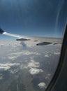 Top view of earth from inside airplane watching clouds and sky Royalty Free Stock Photo