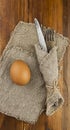 Easter background. Table setting for the holiday of Easter in a rustic style, burlap napkin, eggs, fork and knife on a wooden Royalty Free Stock Photo