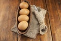 Easter background. Table setting for the holiday of Easter in a rustic style, burlap napkin, eggs, fork and knife on a wooden Royalty Free Stock Photo