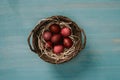 top view of easter basket with painted eggs and straw