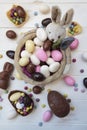 Top View Of Easter Bunny Basket With Almonds  Chocolate Eggs And Other Easter Sweets