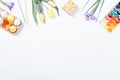 Top view an Easter composition: flowers, colored eggs and watercolor paints Royalty Free Stock Photo