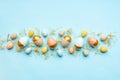 Top view of easter eggs colored with golden paint and differen colors. Blue background. Copy space Royalty Free Stock Photo