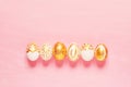 Top view of easter eggs colored with golden paint in differen patterns.