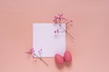 Easter composition with decorative pink eggs and twigs of pink gypsophila flowers placed on white square blank