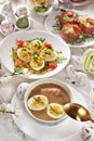 Top view of Easter table with traditional white borscht, deviled eggs and salads Royalty Free Stock Photo