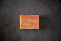 Top view of ecologic handmade soap bar. Dark background