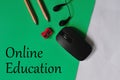 Top view of educational objects on a green background, the concept of online education
