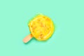 egg and milk flavor popsicle starts melting on light green background