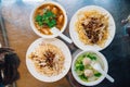 Top view of egg noodles with sprout served with fish in gravy and clear soup with minced pork. Street food in Taipei, Taiwan