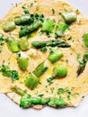 Top view on egg omelette with fresh green asparagus and parsley. Healthy vegan and vegetarian omelet for breakfast or