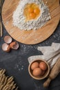 Top view eggs, dough, flour and rolling-pin on wooden table back Royalty Free Stock Photo