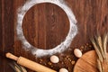 Top view eggs, dough, flour and rolling-pin on wooden table Royalty Free Stock Photo