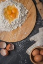 Top view eggs, dough, flour and rolling-pin on wooden table back Royalty Free Stock Photo