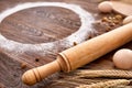 Top view eggs, dough, flour and rolling-pin on wooden table Royalty Free Stock Photo