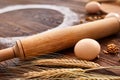 Top view eggs, dough, flour and rolling-pin on wooden table Royalty Free Stock Photo