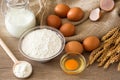 Top view eggs, flour and baking ingredients on wooden table