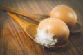 Top view of Eggs lay on wood spoon on wooden background. Food ingredient. Royalty Free Stock Photo