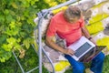 Top view of eldery man sitting and relaxing on summer holiday rasort using laptop on grass on couch Royalty Free Stock Photo