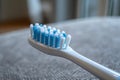 Top view of an electric toothbrush head lying flat on a surface, with a focus on the texture of the bristles.. AI Royalty Free Stock Photo