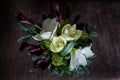 Top view on elegant bouquet made from white lily, purple calla, and fresh greenery Royalty Free Stock Photo