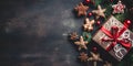 Top view of elegantly arranged gifts, gingerbread, pinecones, pine branches and Christmas trees on right.Christmas banner with