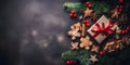 Top view of elegantly arranged gifts, gingerbread, pinecones, pine branches and Christmas trees on right.Christmas banner with