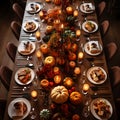 Top view of an elegantly set table, plates, cutlery, pumpkin candles, glasses. Pumpkin as a dish of thanksgiving for the harvest