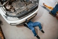 Top view. Employee in the blue colored uniform works in the automobile salon