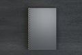 Top view of empty black spiral notepad on dark wooden background. Mock up Royalty Free Stock Photo