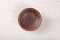 Top view of empty brown plate put on white wood table Royalty Free Stock Photo