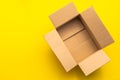 Top view empty brown post or carton box on yellow paper background Royalty Free Stock Photo